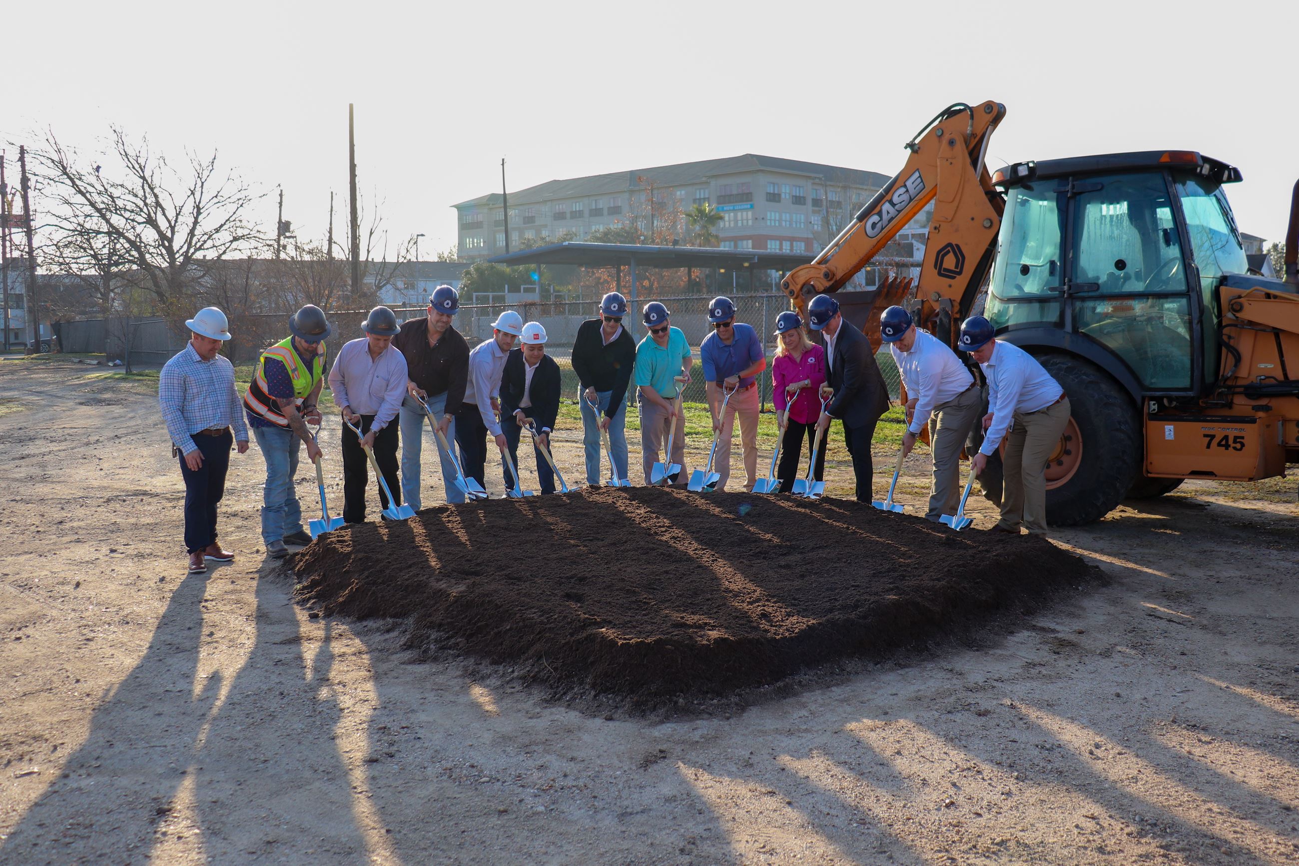 City staff and construction staff with shovels in the dirt.