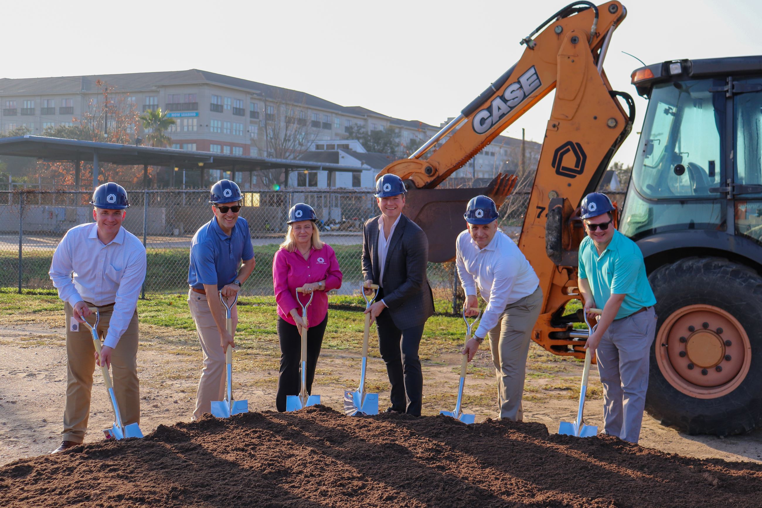 City Staff smiling at the camera with shovels in their hands.