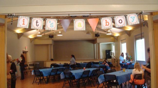 It's a Boy banner stretches over a room decorated for a baby shower